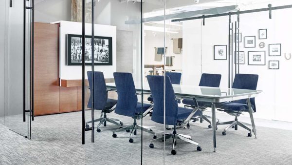 the eleven series conference table by ofs in a conference room surrounded by pur conference chairs in blue leather